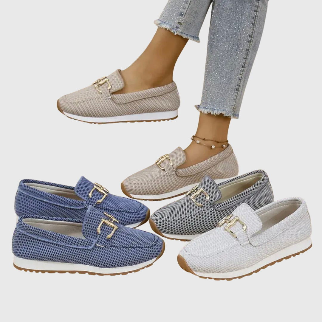 Pair of dusty blue women's horsebit loafers, classic design for versatile everyday fashion and comfort.