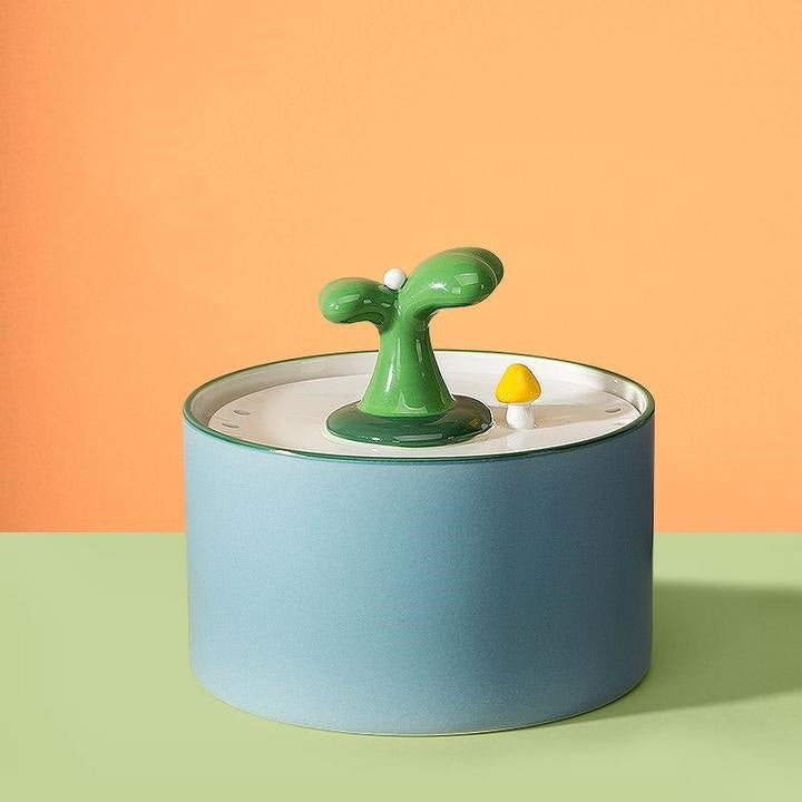 Angle shot of a ceramic pet water dispenser, highlighting its stable base and splash-proof design for cats.