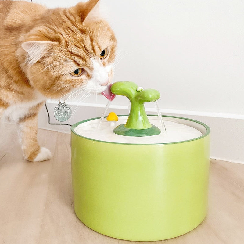 Modern white ceramic cat fountain with a wide drinking area, promoting healthy water intake for pets.