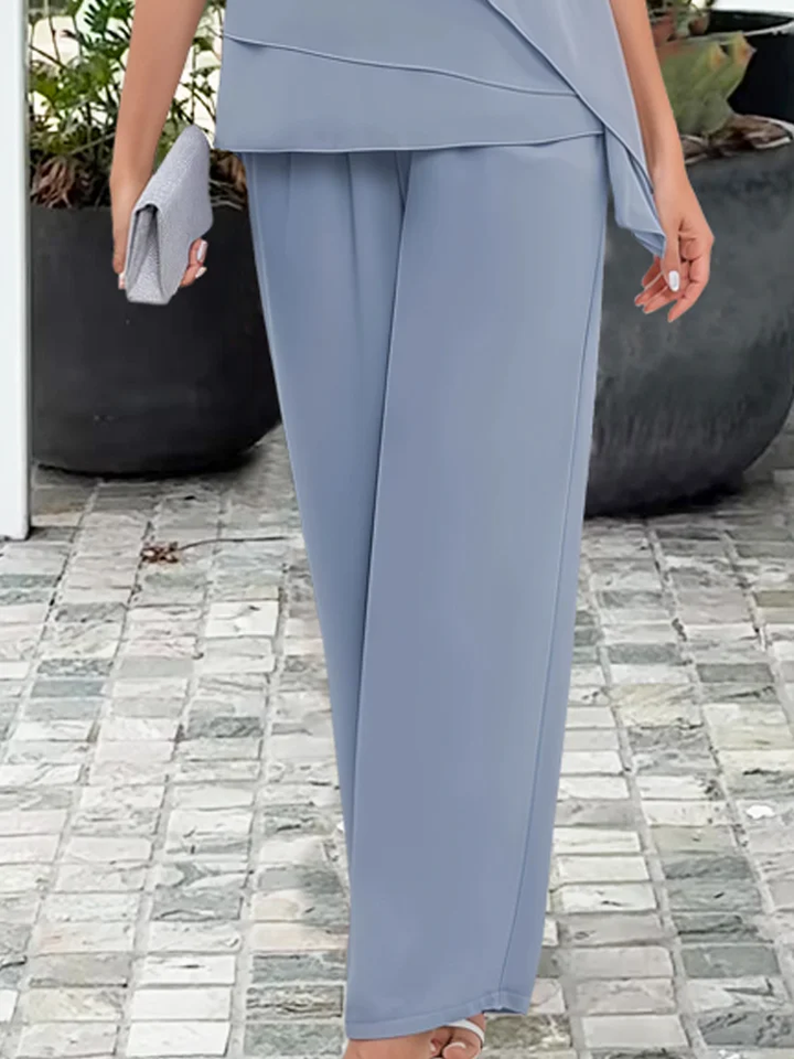 Elegant women's tiered cape top and wide-leg trouser set, a sophisticated coordinated outfit for formal wear.