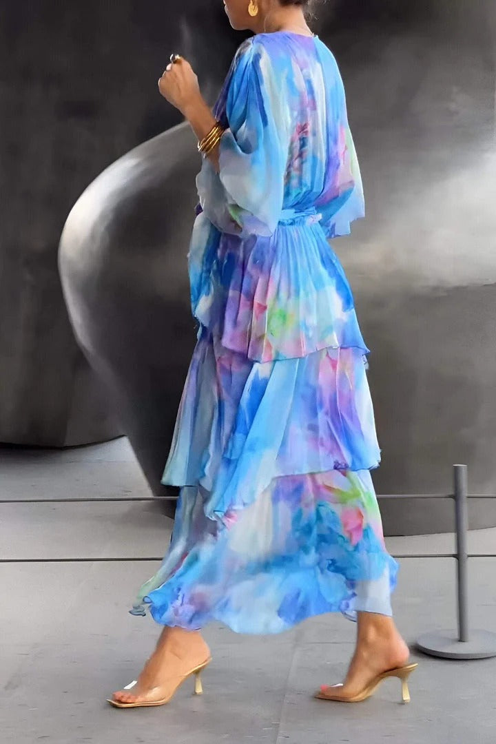 Stunning women's elegant flowy maxi dress with a unique watercolor design for a stylish party or event.