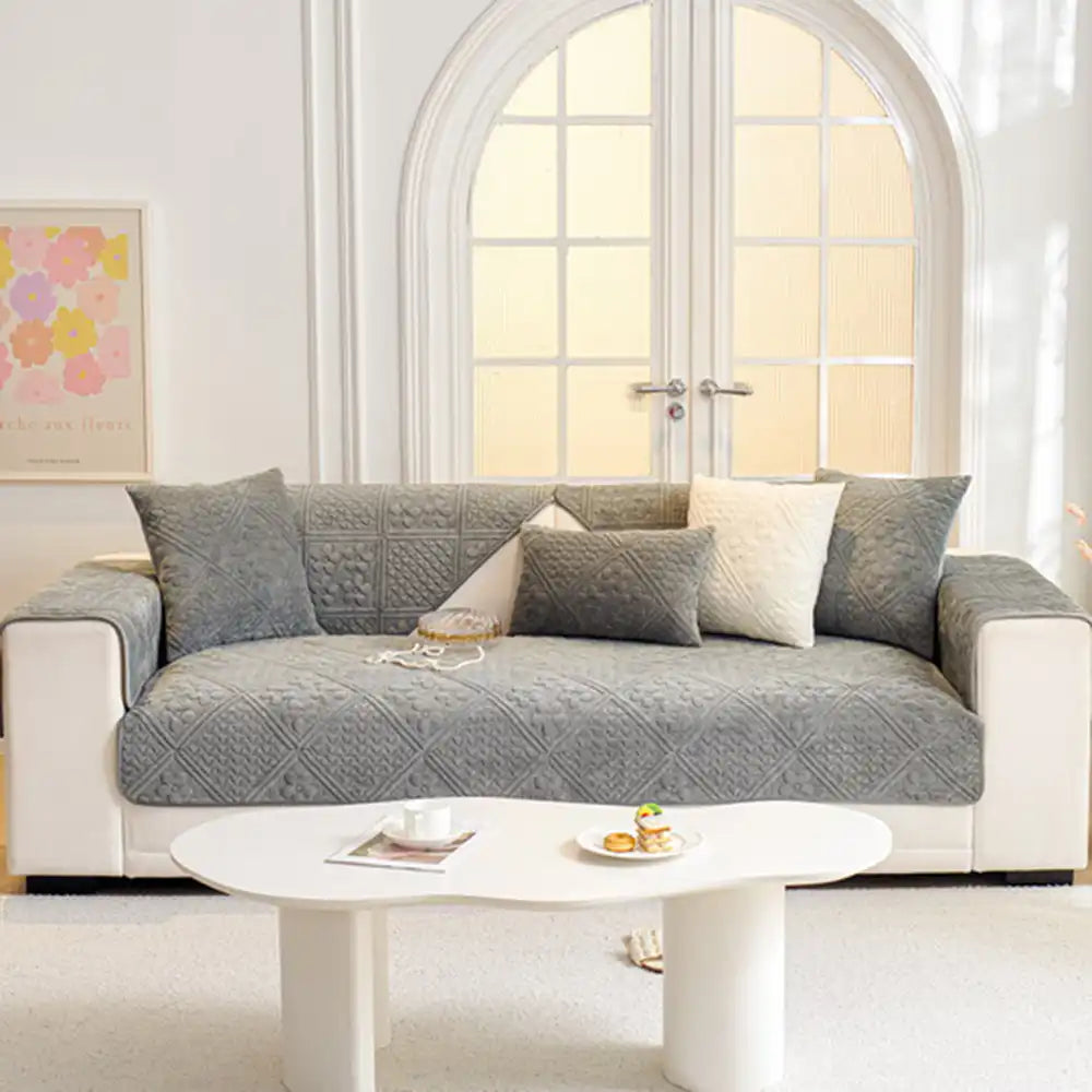 Close-up of the embossed geometric pattern on a soft plush non-slip sofa cover for furniture protection.