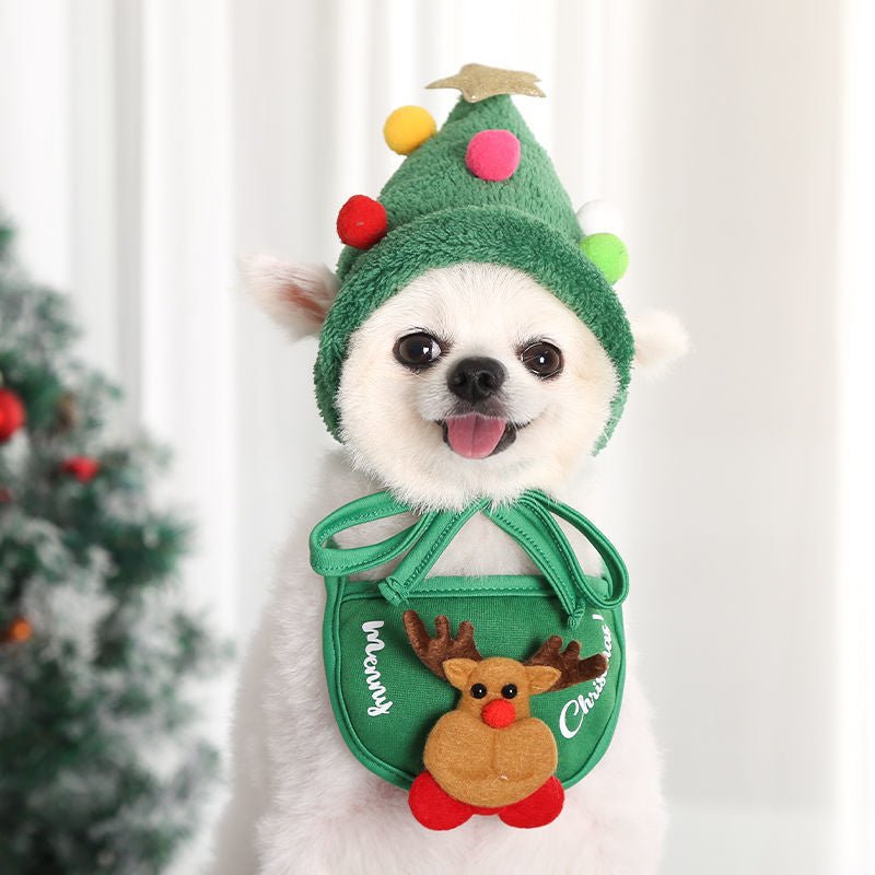 Adorable dog Christmas costume featurng a red hat with pom-pom and white festive bib.