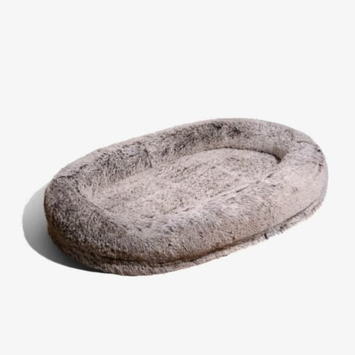 Plush faux fur human dog bed, giant-sized for anxiety relief, offering unparalleled comfort & calm.