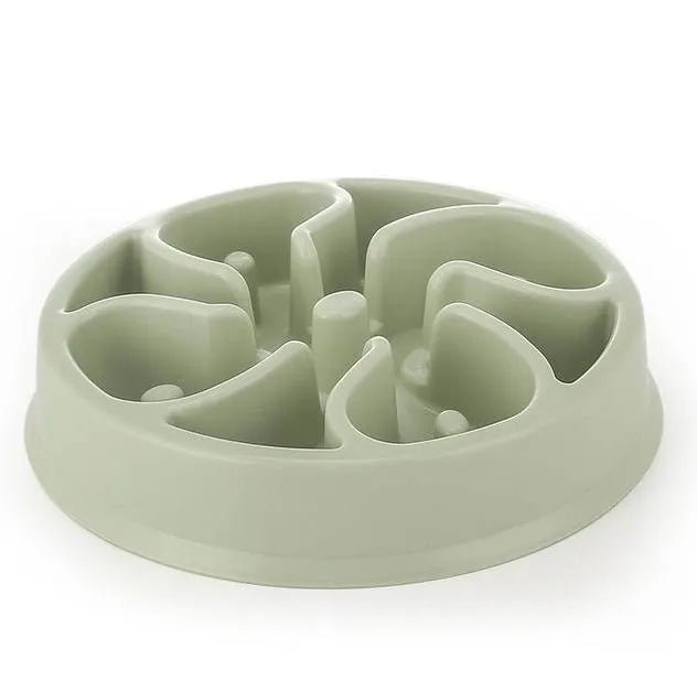 Dog happily eating from a red slow feeder bowl, showing effective anti-gobble design.