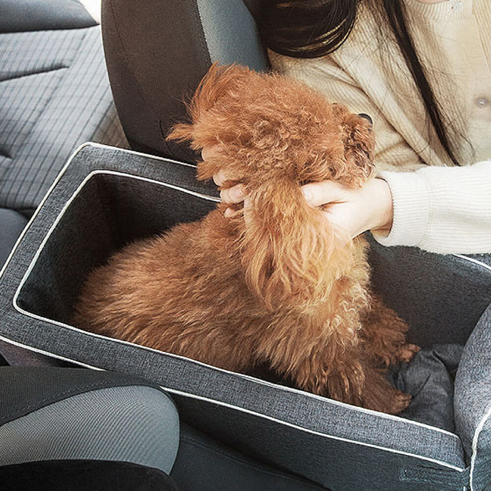 Adjustable straps on a grey suede pet booster seat for secure car travel.