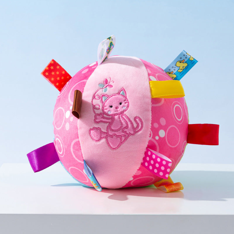 Cute puppy happily engaging with a plush interactive squeaky ball dog toy, a new pet favorite.