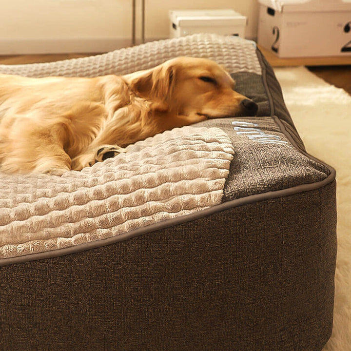 Gray dog sofa bed, showing the robust construction and spine support features for big dogs