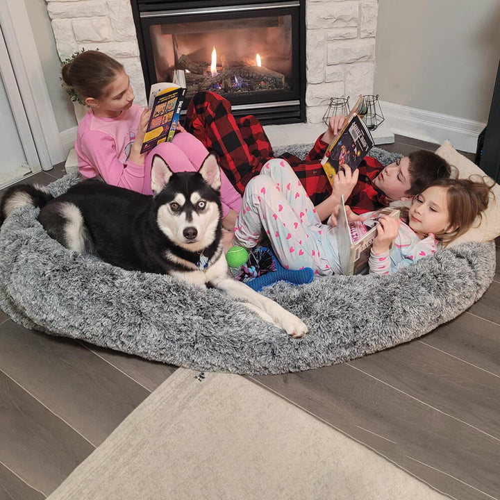 Grey oval pet bed, deep sleep design, washable faux fur for human and dog comfort