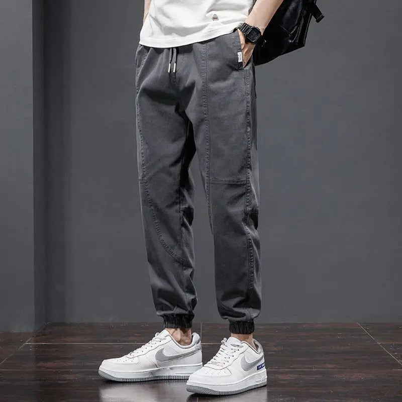 Soft men's comfort pants: tapered joggers with drawstring waist & ribbed cuffs for lounge or athletic style.
