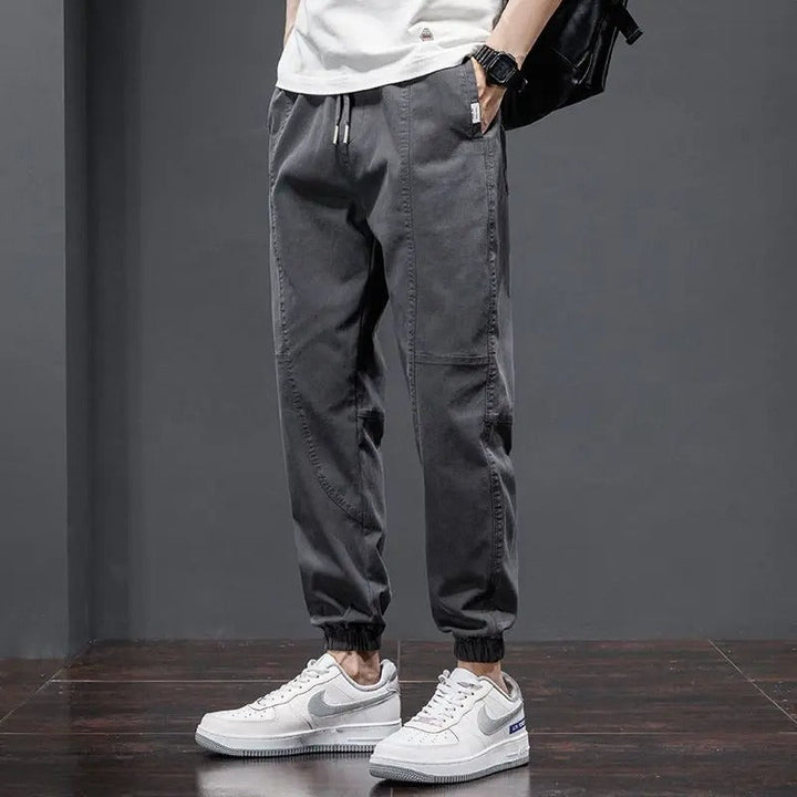 Soft men's comfort pants: tapered joggers with drawstring waist & ribbed cuffs for lounge or athletic style.