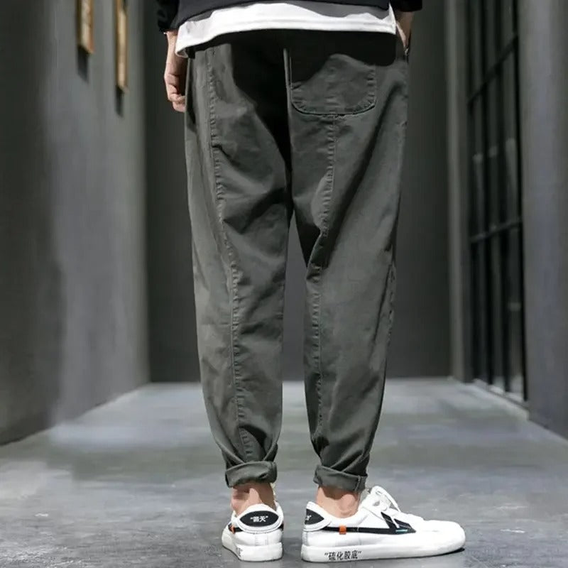 Men's green tapered drawstring joggers, combining comfortable activewear with sleek casual fashion.