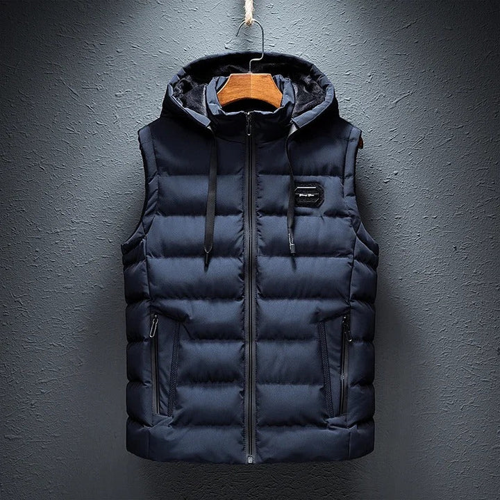 Stylish men's insulated alpine vest, durable outerwear with detachable hood, perfect for winter adventures.