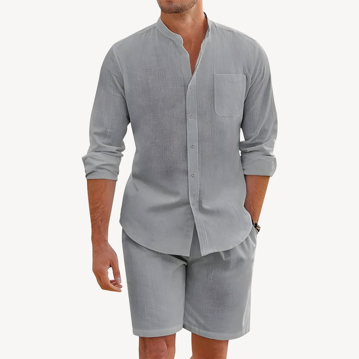Stylish men's summer apparel: two-piece button-up shirt & drawstring shorts for warm weather comfort.