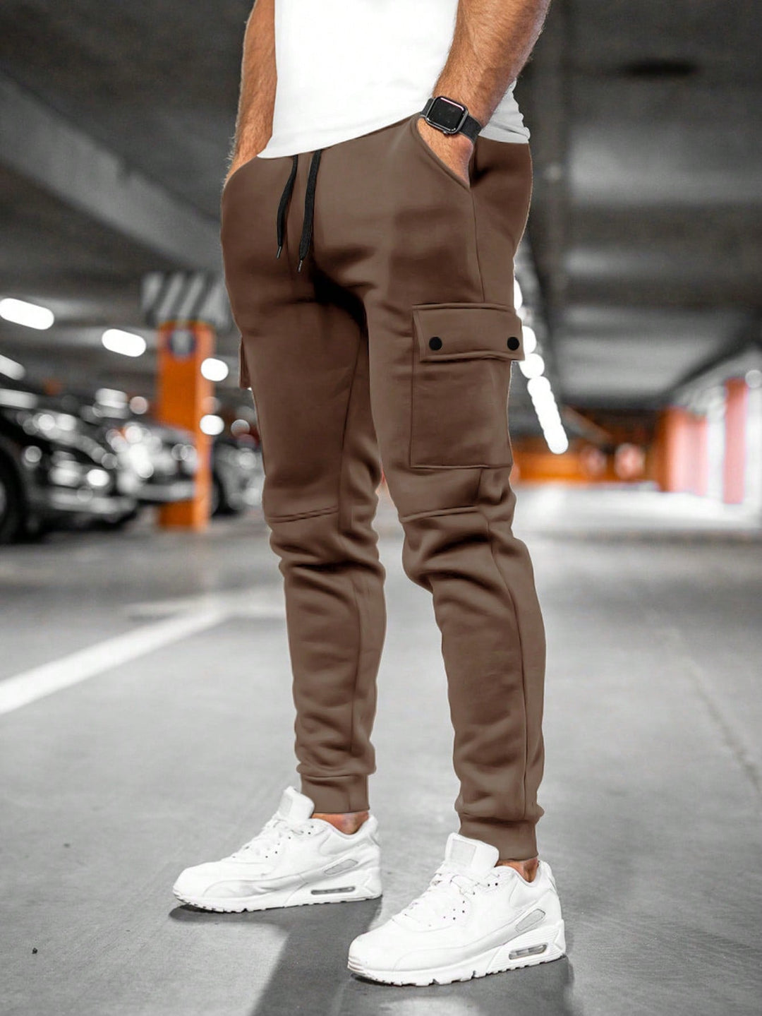 Sporty men's black slim-fit joggers with cargo pocket, versatile for active streetwear.