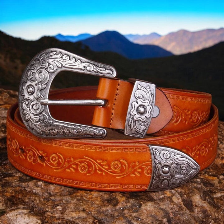 Classic men's western fashion accessory, an engraved leather belt with a rustic metal buckle for durable wear.
