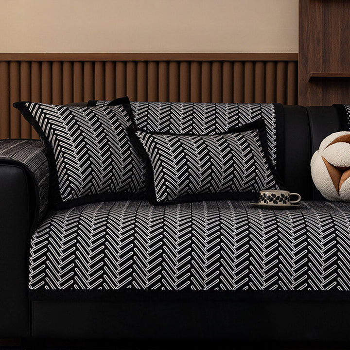 Full view of a living room featuring a herringbone chenille sofa cover, protecting furniture from wear.