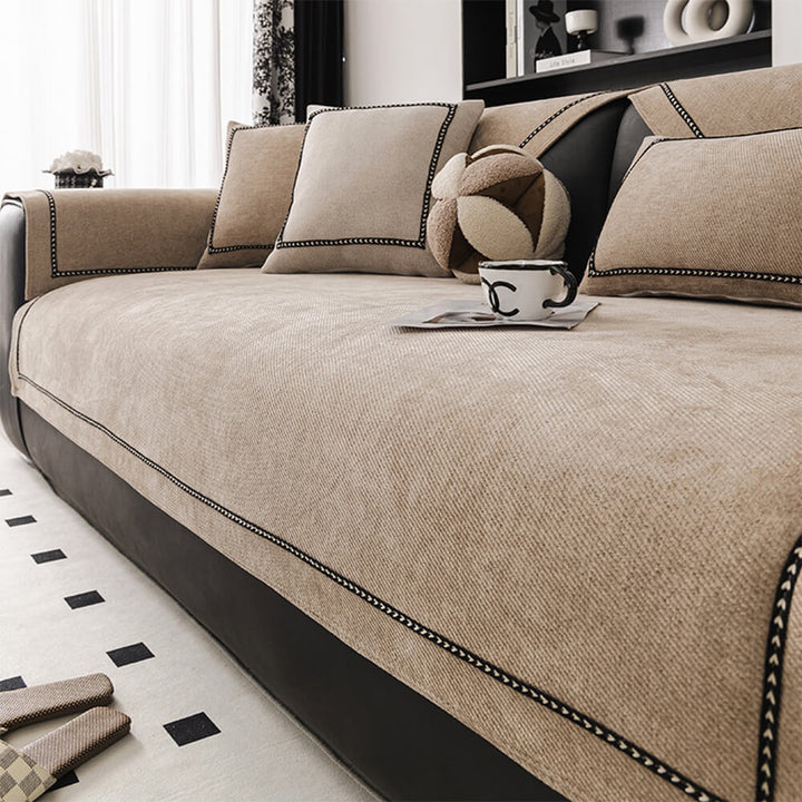 Close-up of modern jacquard pattern on a beige chenille couch cover, highlighting the textured fabric detail