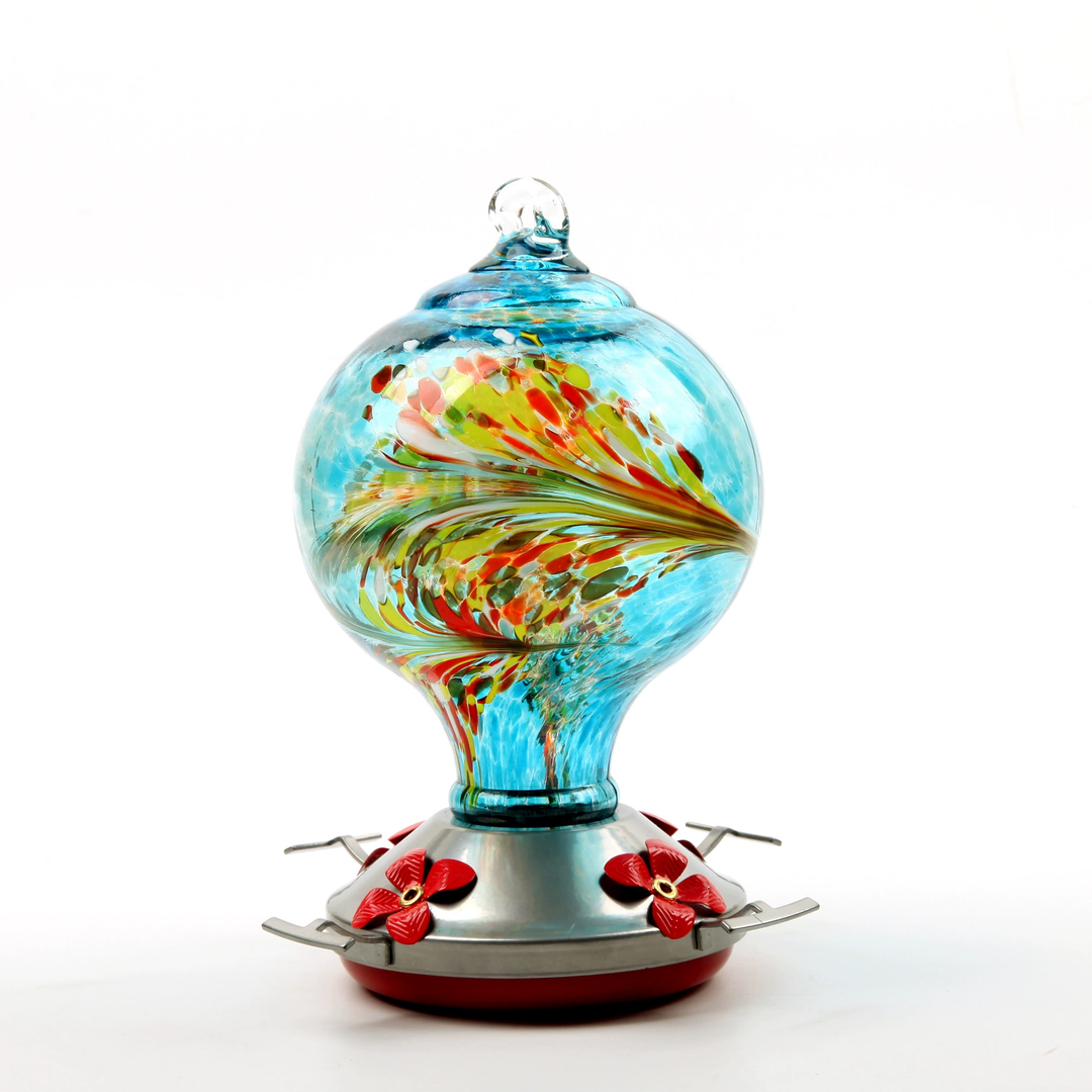 A hand blown ocean blue glass feeder for hummingbirds, an attractive addition to any outdoor garden