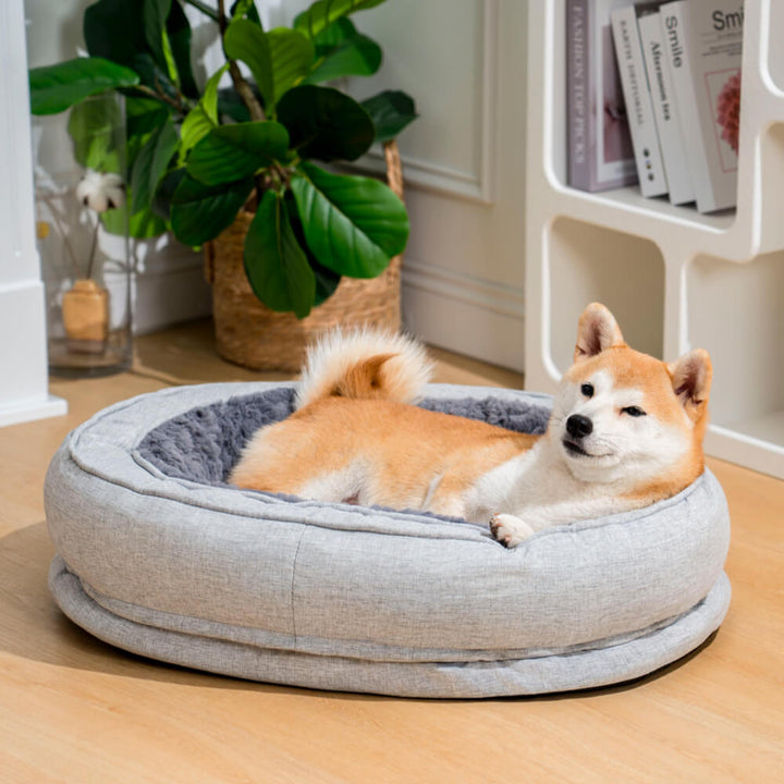 Washable orthopedic donut dog bed in a neutral grey, fitting any home decor.