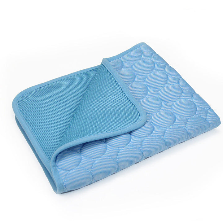 Cat resting peacefully on a grey 3-layer cooling mat, non-slip design visible