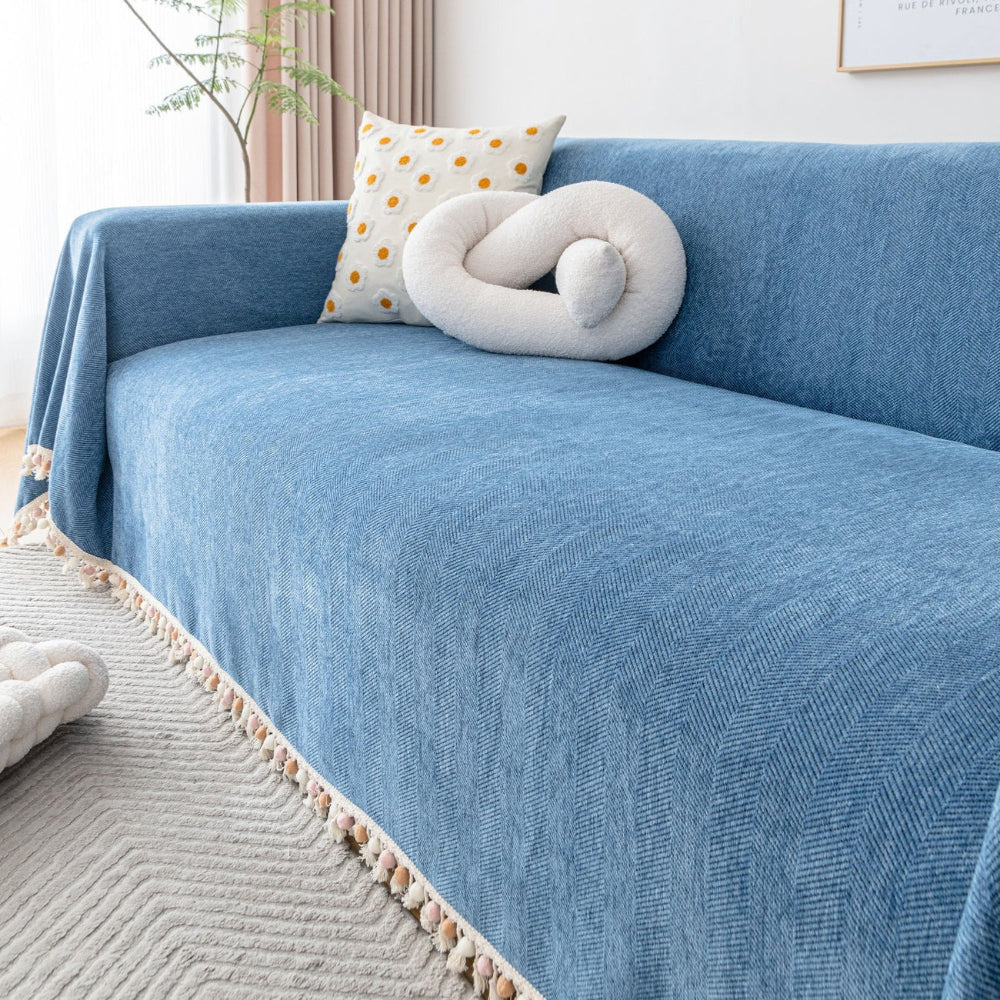 Living room sofa draped with a pet friendly herringbone slipcover, offering stylish furniture protection.