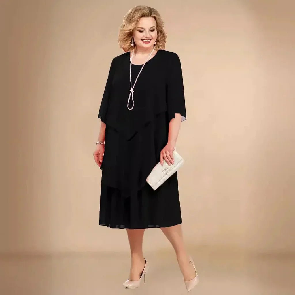 Elegant women's plus size purple chiffon layered knee-length dress with 3/4 sleeves, perfect for formal events.