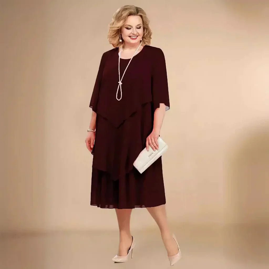 Chic plus size purple layered chiffon knee-length dress detail, highlighting flowy fabric and elegant 3/4 sleeve design.