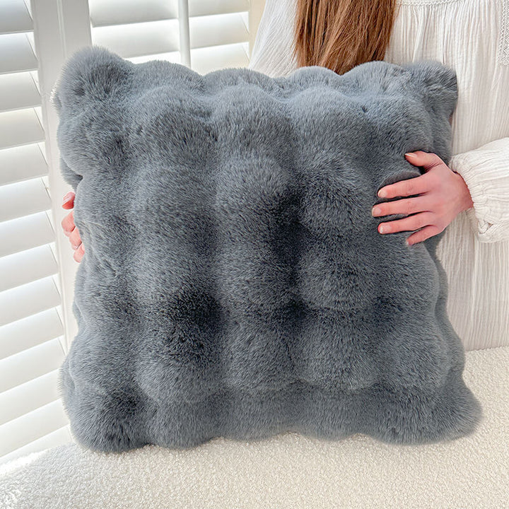 Luxurious faux rabbit fur sofa protector, adding a touch of elegance and warmth to a living space.