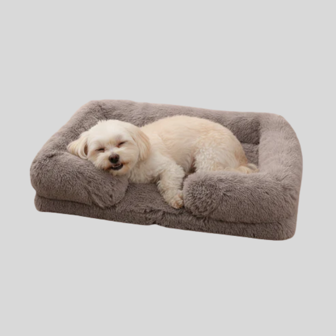 Plush rectangular pet bed for dogs & cats, cozy calming design in a neutral color, washable.