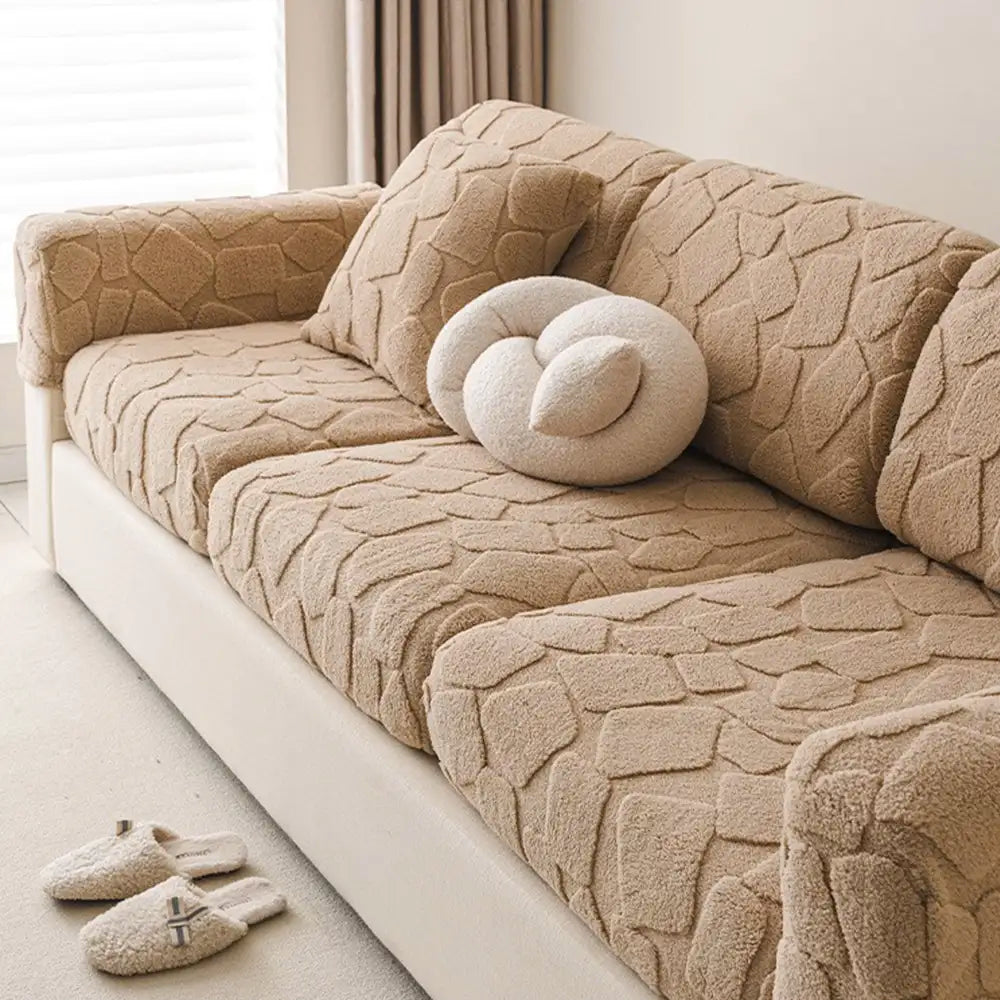 Full view of a stone-textured stretch sofa cover on a large couch, offering universal fit and stylish home decor