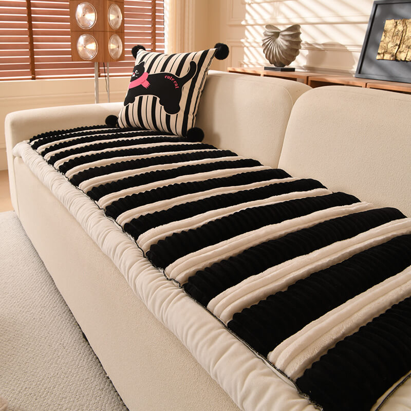 Full shot of a living room couch showcasing the striped non-slip plush sofa cover.