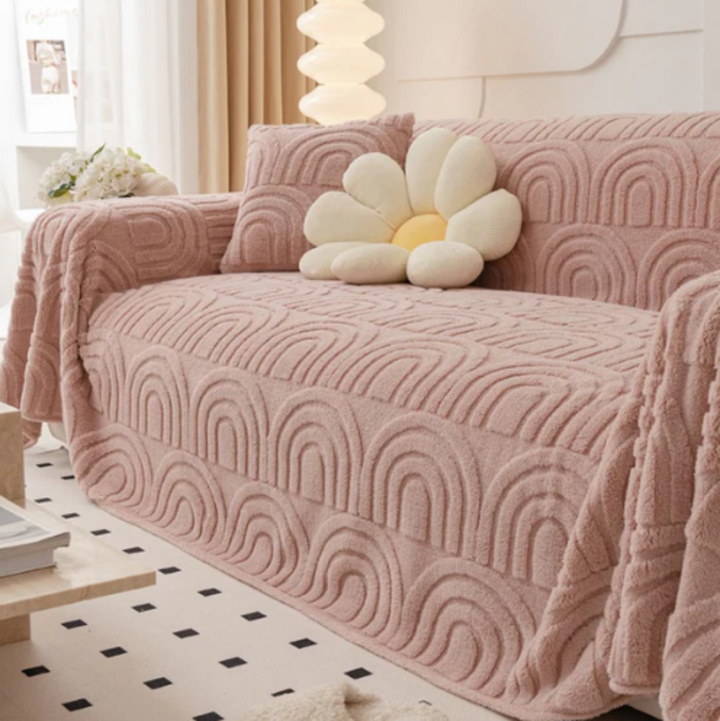 Corner view of a modern sofa protected by a plush wave pattern cover, showcasing its anti-slip feature and style.