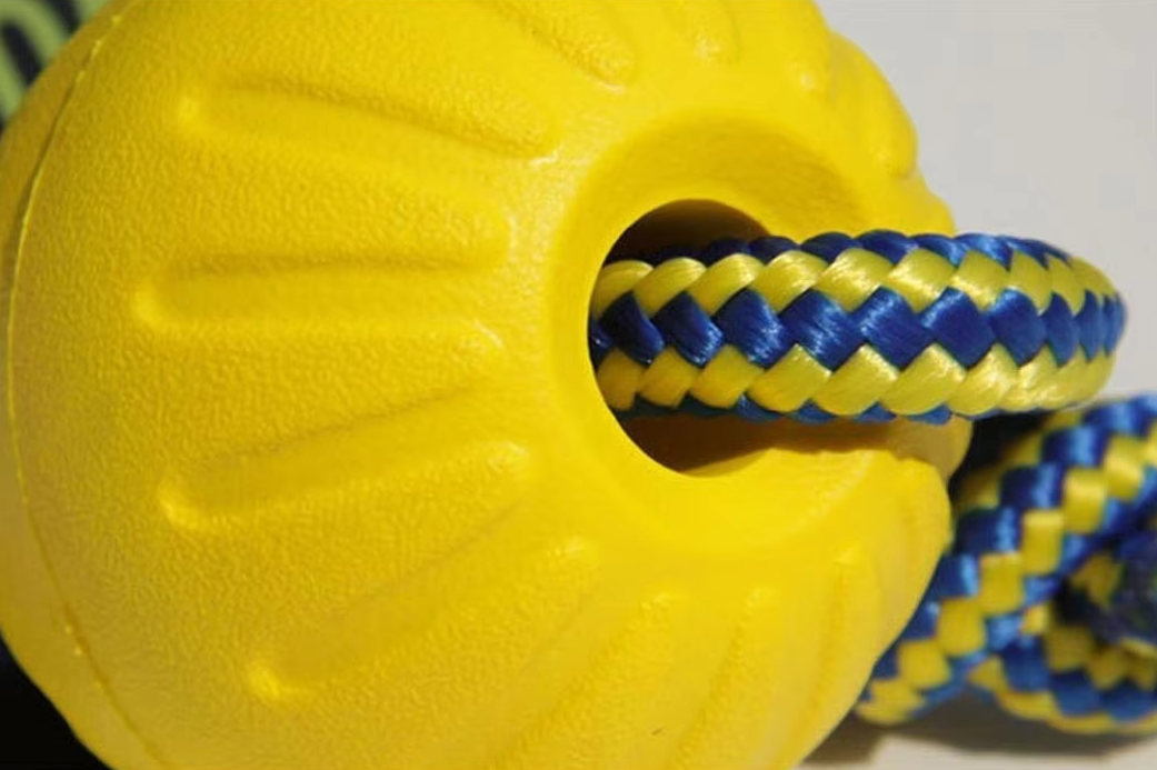Product shot of multi-colored robust dog toy ball bundle for fetching, tugging, and chewing