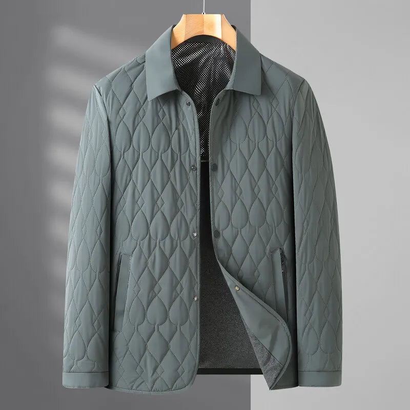 Close-up of a men's quilted button-down jacket, showing texture and classic collared design.