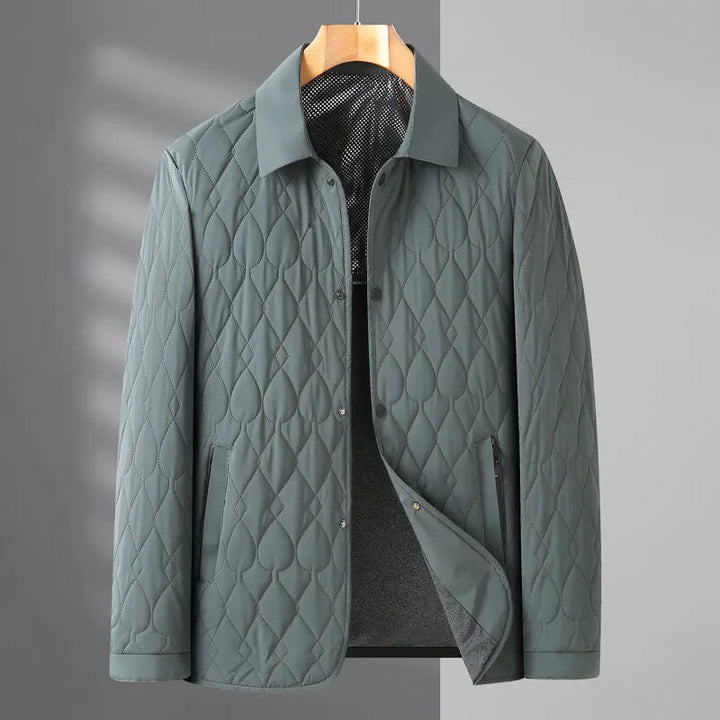 Close-up of a men's quilted button-down jacket, showing texture and classic collared design.
