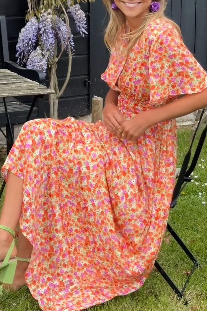 Stylish women's floral maxi dress with elegant flowing silhouette, suitable for wedding guests or casual summer fashion.