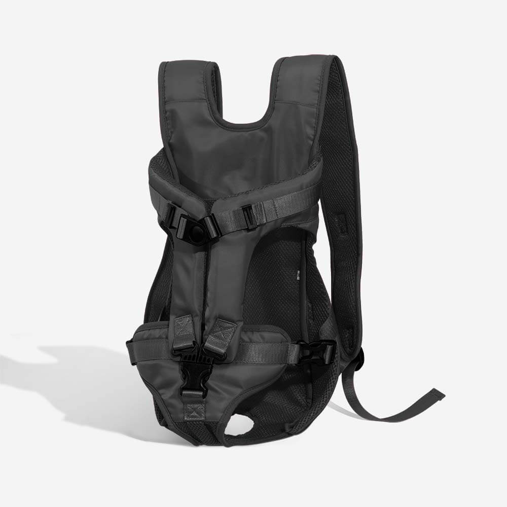 Owner carrying a small dog in a comfortable travel pet backpack, hands-free outdoor gear