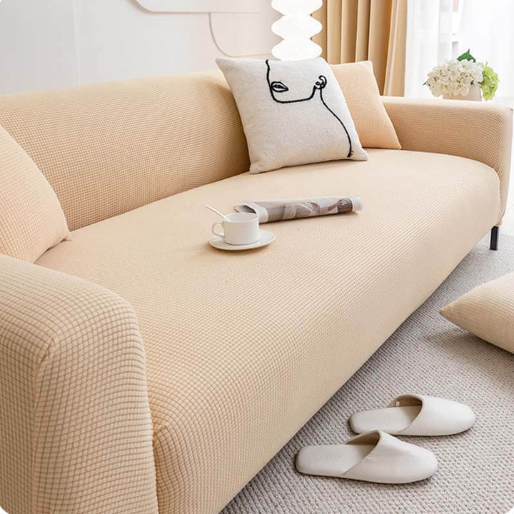 Machine washable fleece sofa cover in a neutral tone, designed for full protection of living room furniture