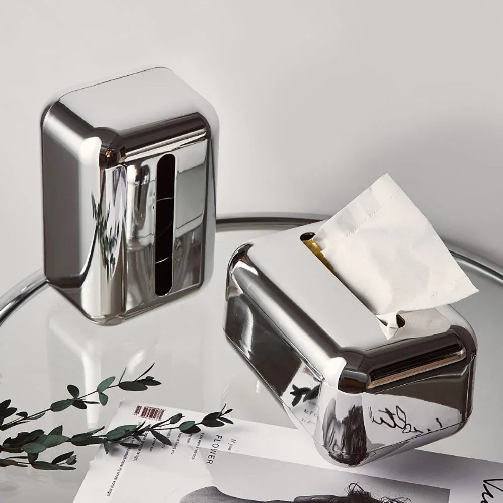 Gold and silver modern tissue dispenser for elegant home aesthetics.