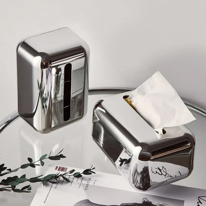 Gold and silver modern tissue dispenser for elegant home aesthetics.