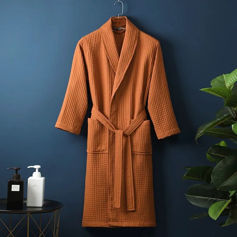 Close-up of the textured AirWeave waffle fabric on a comfortable unisex bathrobe, perfect for lounging.