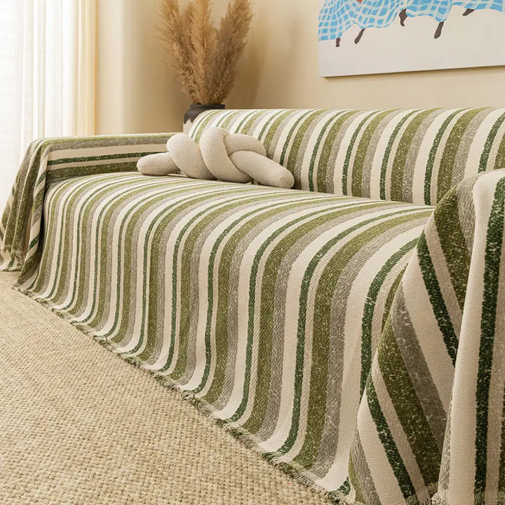 Full view of a living room sofa covered with a chenille stretch-fit slipcover, demonstrating its sleek look and all-season use.