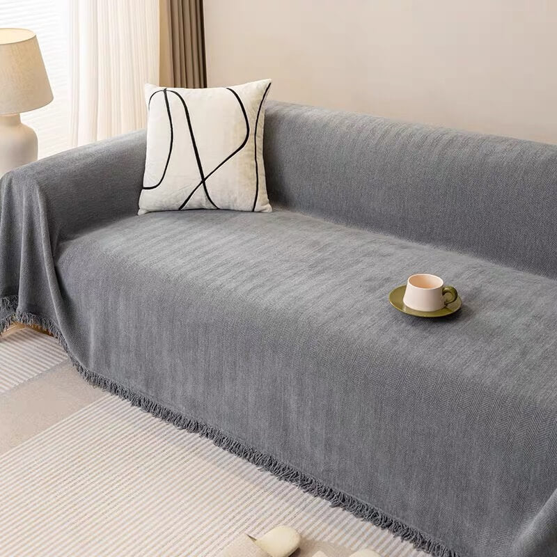 Lifestyle image of pet relaxing on chenille herringbone sofa slipcover, pet-friendly and washable couch cover
