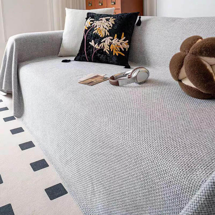 Neutral tone linen-look couch cover, pet-friendly and scratch-resistant, designed as a furniture protector.
