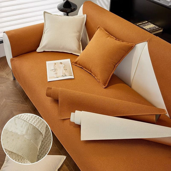 Beige machine washable couch cover, pet-friendly and waterproof, draped over a living room sofa
