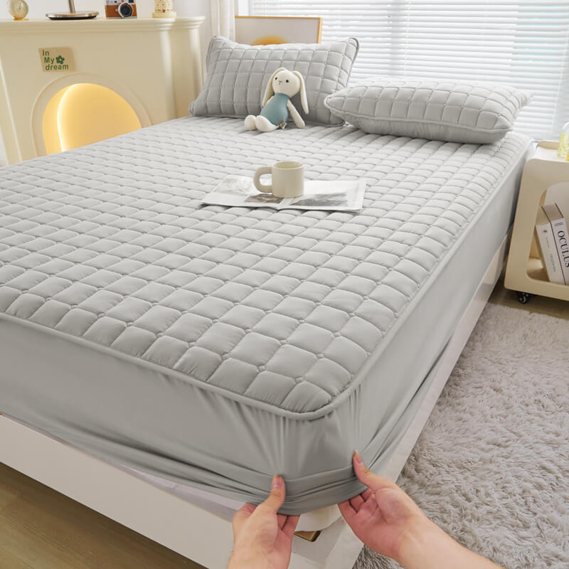 Waterproof mattress protector on a bed, demonstrating seamless integration with a standard mattress.