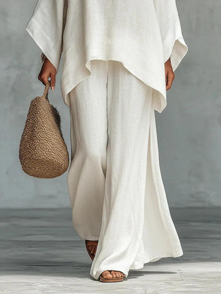 Comfortable women's two-piece set featuring an asymmetrical top & flowy wide-leg pants for casual chic style.