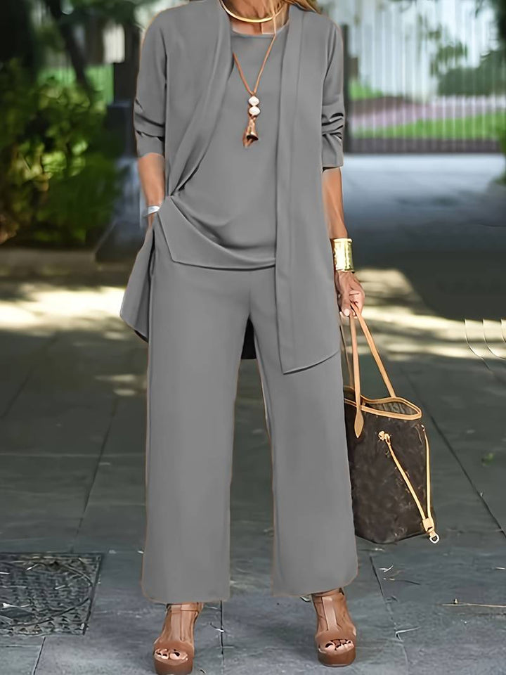 Chic women's breezy wide-leg trouser set with a flowing cardigan and sleeveless top for effortless summer style.