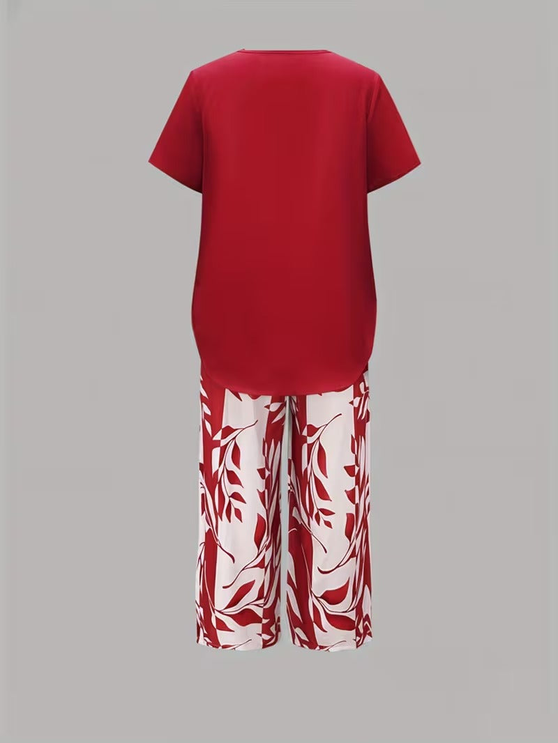 Chic women's leaf print two-piece set. Short sleeve top and cropped pants for a relaxed spring/summer look.